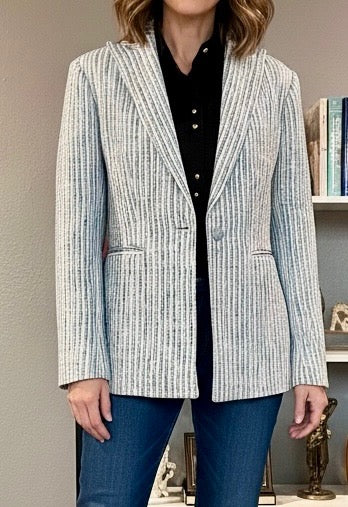 Claire Flowers stone grey pinstripe bouclé blazer with tailored fit, notched lapel, and front button closure, styled over a black blouse for a polished, modern look